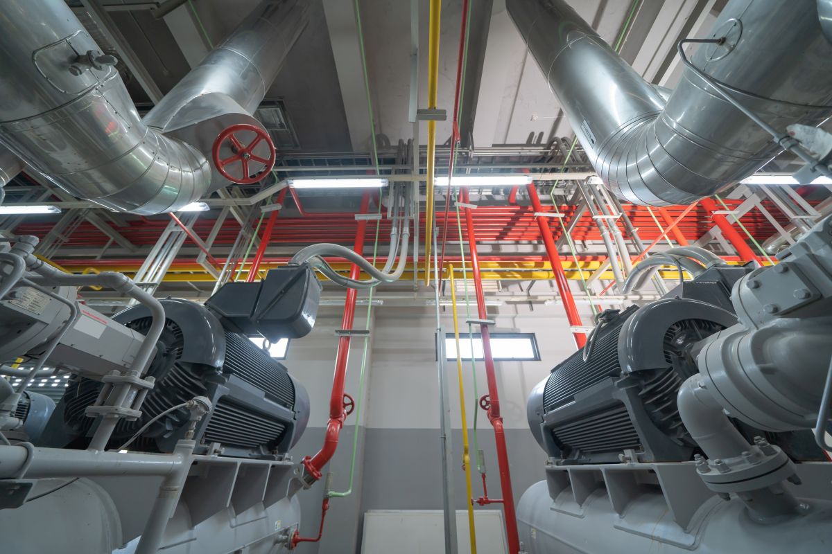 Ceiling of Industry factory Chiller tower or cooling tower in building System work machine Condenser Water Supply and return pipe lines Ventilation compressor Water system in workshop