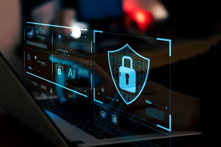 Cybersecurity graphic with a glowing lock icon and digital shield overlay on a laptop screen.